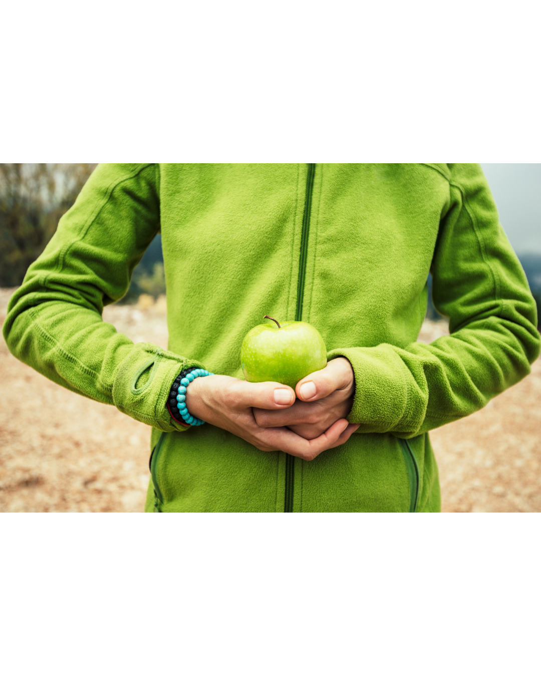 man in green holding a green apple